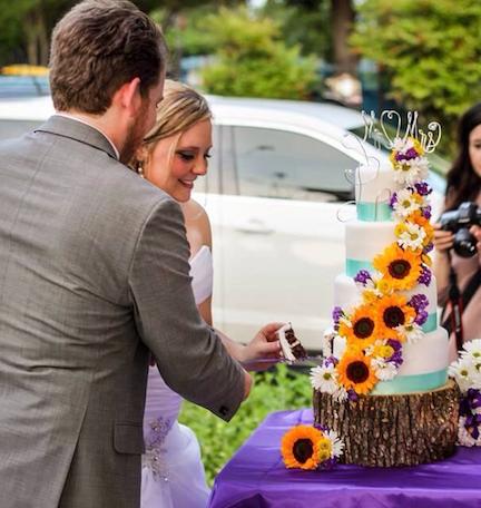 Sean and Kadi cut their beautiful, outdoorsy-themed wedding cake.