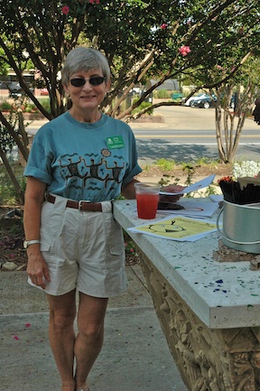Five-year Master Gardener Sandy Furrer takes a moment to enjoy her tea and learn about Esse Purse Museum across the street.